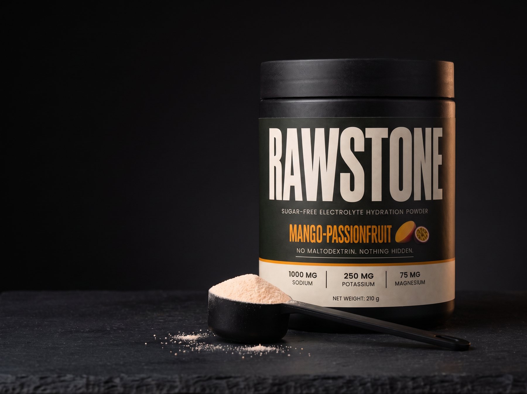 RAWSTONE Mango-Passionfruit electrolyte powder tub on dark slate with a scoop of powder